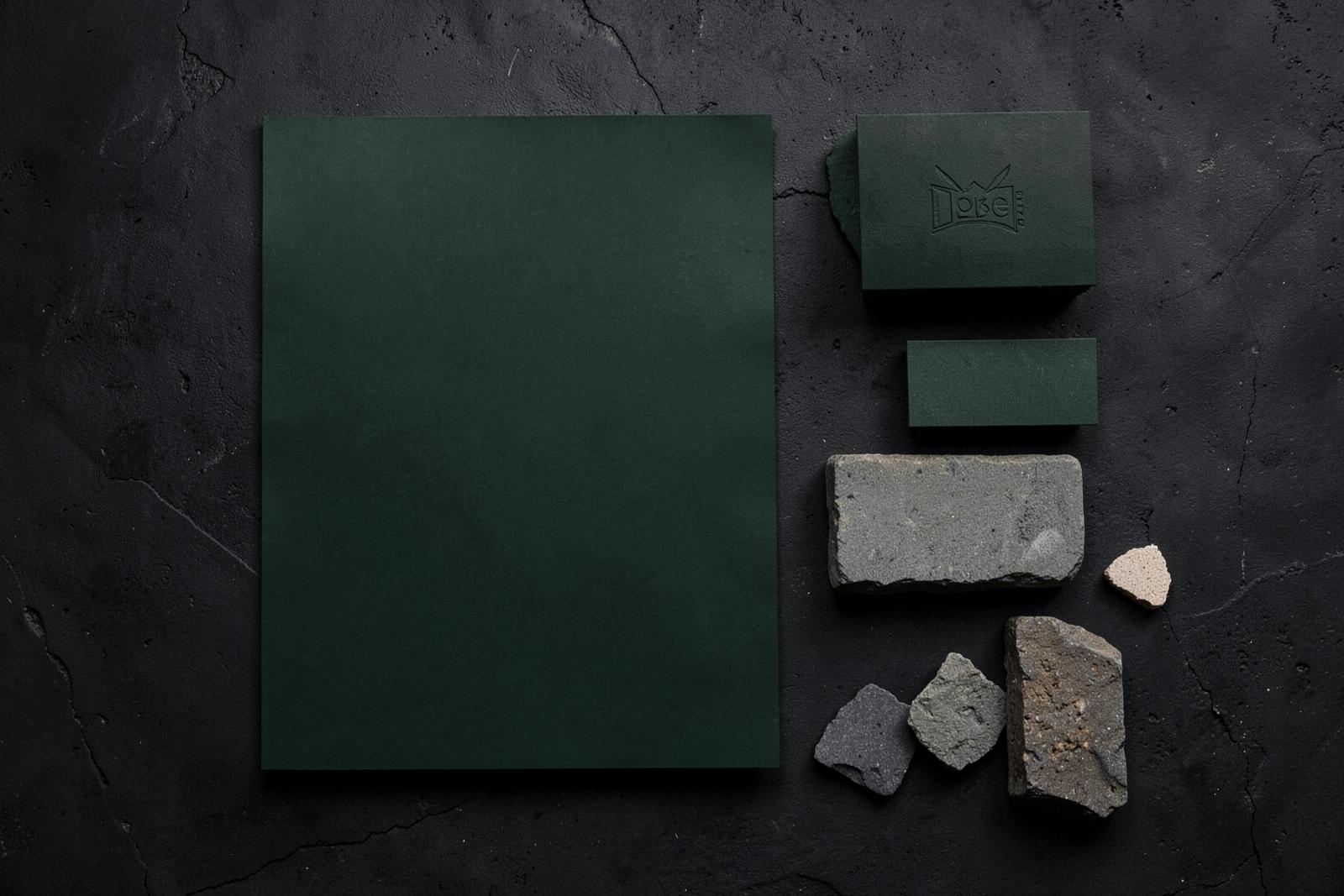 Brand identity materials and stone samples for a contractor rebrand